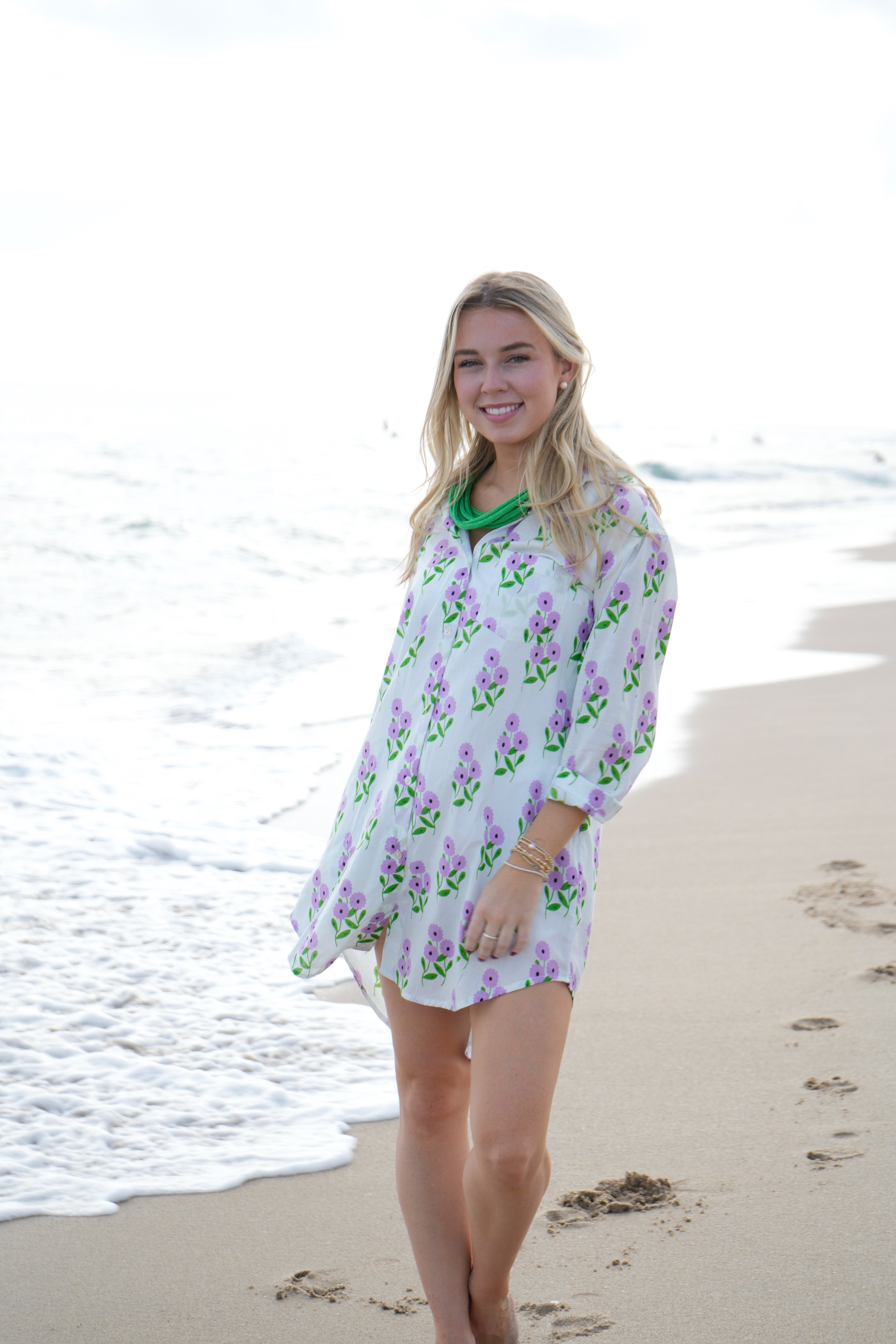 Woman wearing a floral dress on a beach